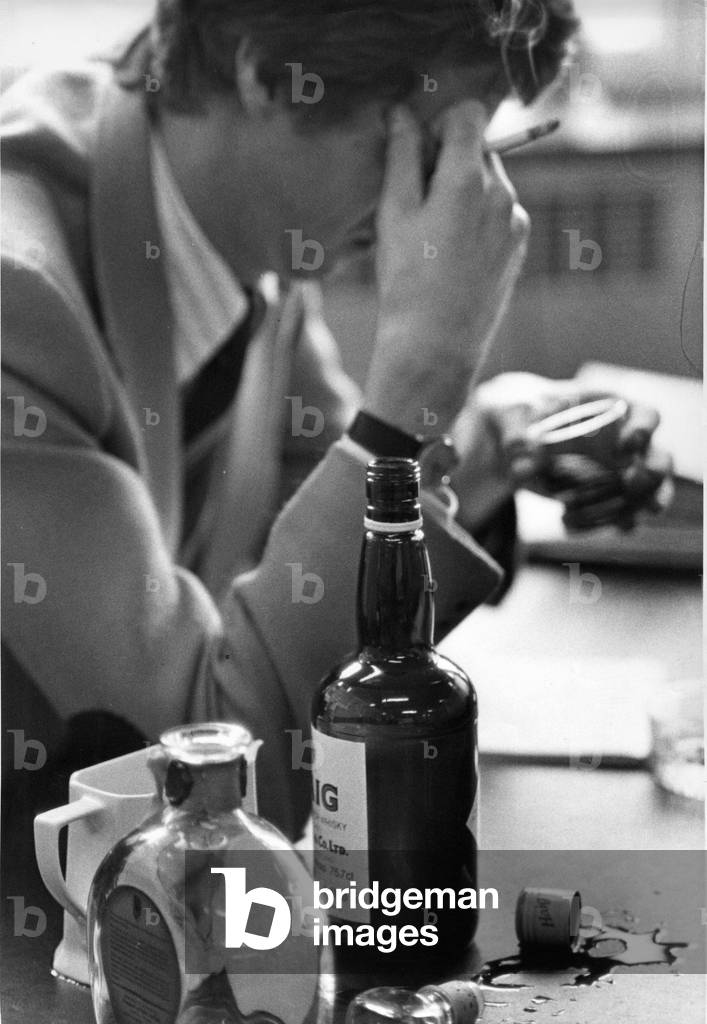 A man depressed smoking and drinking