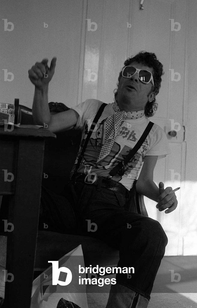 Rock Star Ian Dury poses during an exclusive interview for the Daily Mirror in his offices in Paddington London 1981 (b/w photo)