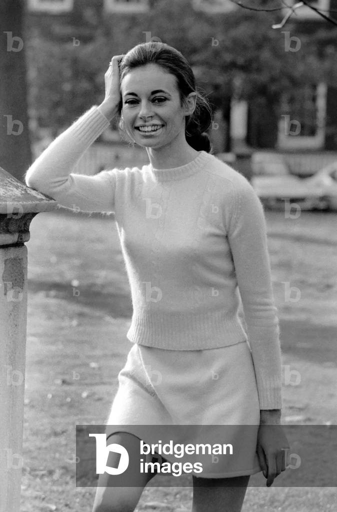 Woman wearing matching top, mini skirt and knee high looks poses for pictures at Lincoln's Inn Fields. November 1969