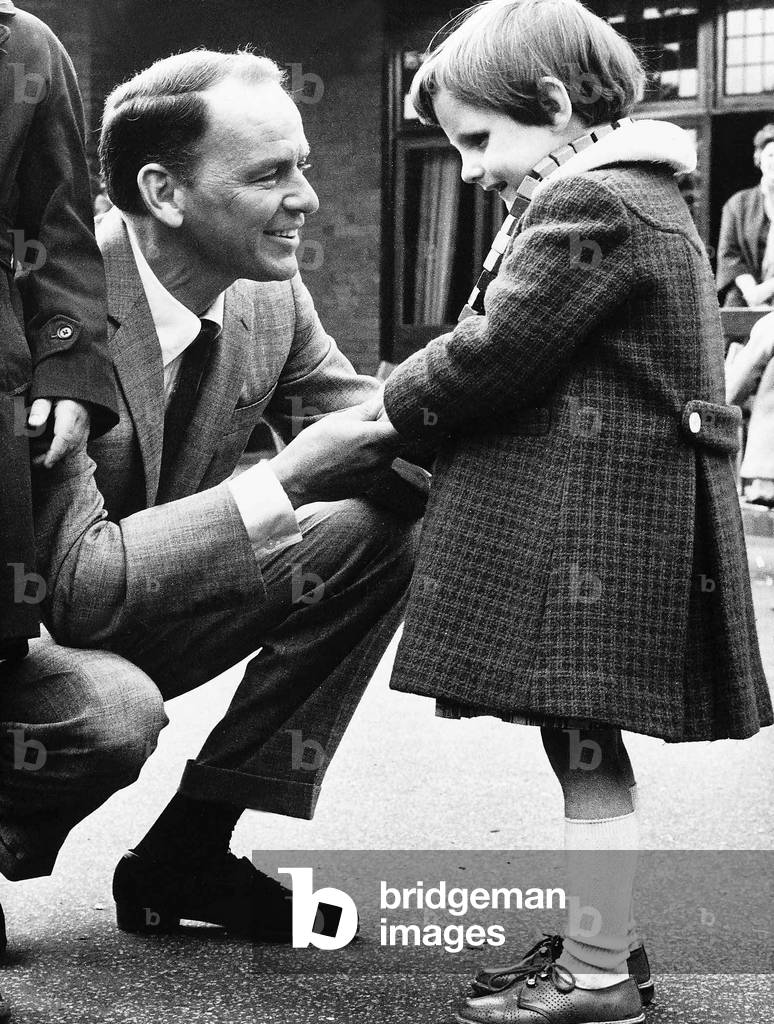Frank Sinatra Actor and Singer talking to a little blind girl at his visit to the sunshine Home for the Blind at Northwood Pinner Middlesex. 1962