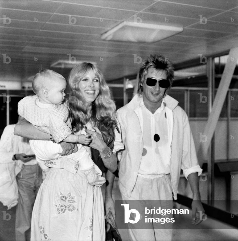 Pop singer Rod Stewart with wife Alana and 10 month old Kimberley leave Heathrow for New York by Concorde, June 1980 (b/w photo)