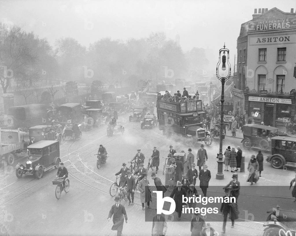 Commuters crowd onto buses and make shift public transport to get home from work, seen here at Kensington, on the second day of the General Strike. The national dispute came about after negotiations between the miners and mine owners failed over wages and the strike began on 3 May 1926. Millions obeyed the strike call, bringing transport systems to a halt while newspapers were not printed. The government responding by using volunteers to run trains and buses and sent in troops to move supplies from the London docks. There were clashes between police and crowds in many areas and at least 4000 strikers were arrested. There were attacks on buses and trains, including the derailing of the Flying Scotsman. The strike was called off unilaterally by the TUC on 12 May with no guarantees of fair treatment for the miners who fought on to bitter defeat in October, 4th May 1926 (b/w photo)