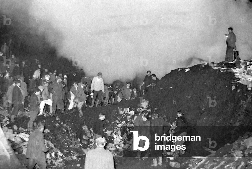 Rescue workers continue the search for victims engulfed when a slag heap collapsed at Aberfan, South Wales, 21st October 1966 (b/w photo)