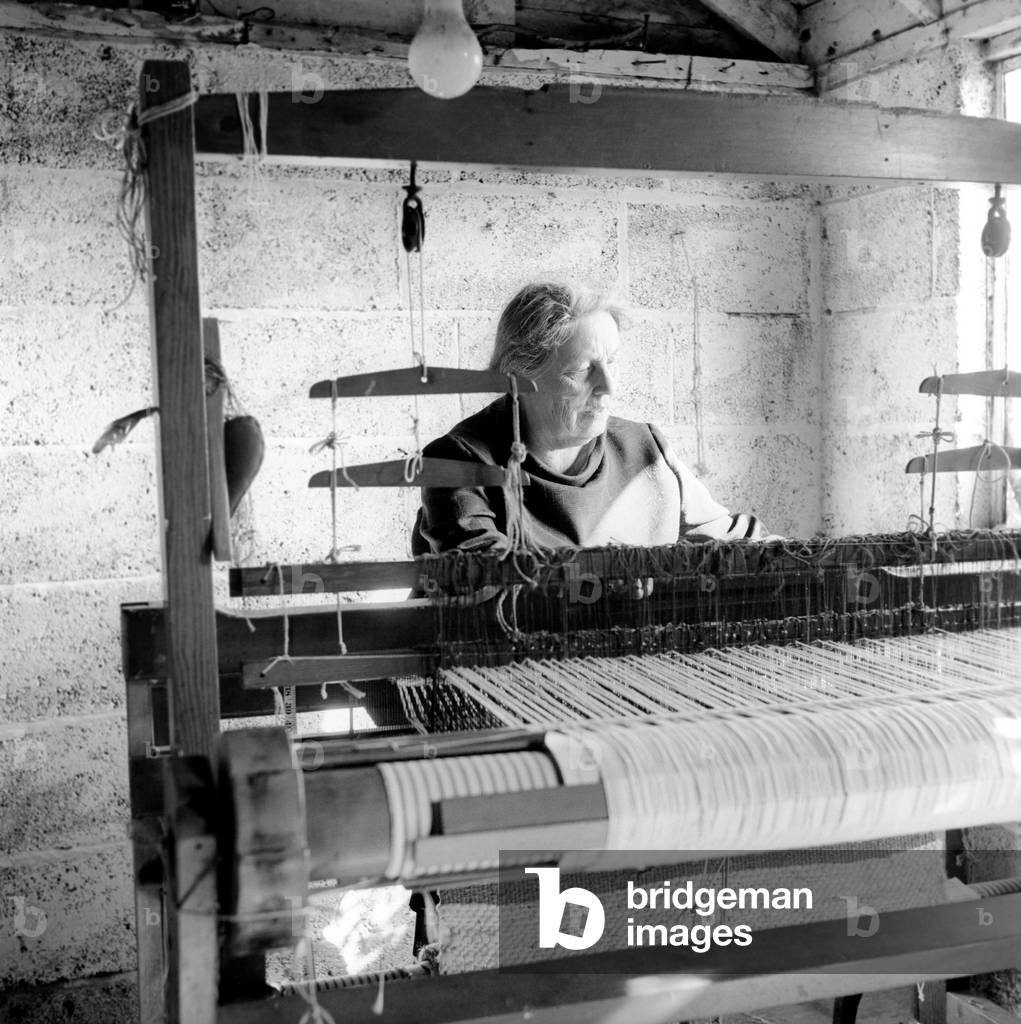 The Spinners guild of Kent. Women using hand operated loom and spinning wheel to create cloth, July 1965