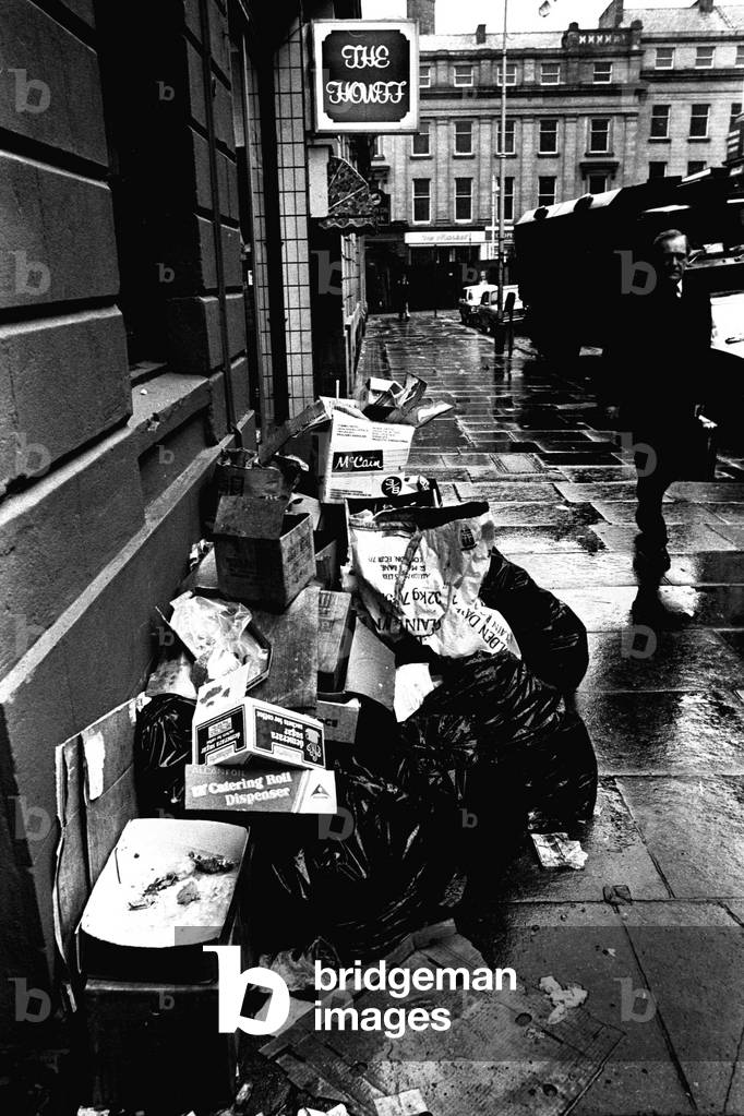 Rubbish piling up on the pavement of Shakespeare Street, Newcastle during the refuse collectors strike on 2nd March 1979 (b/w photo)