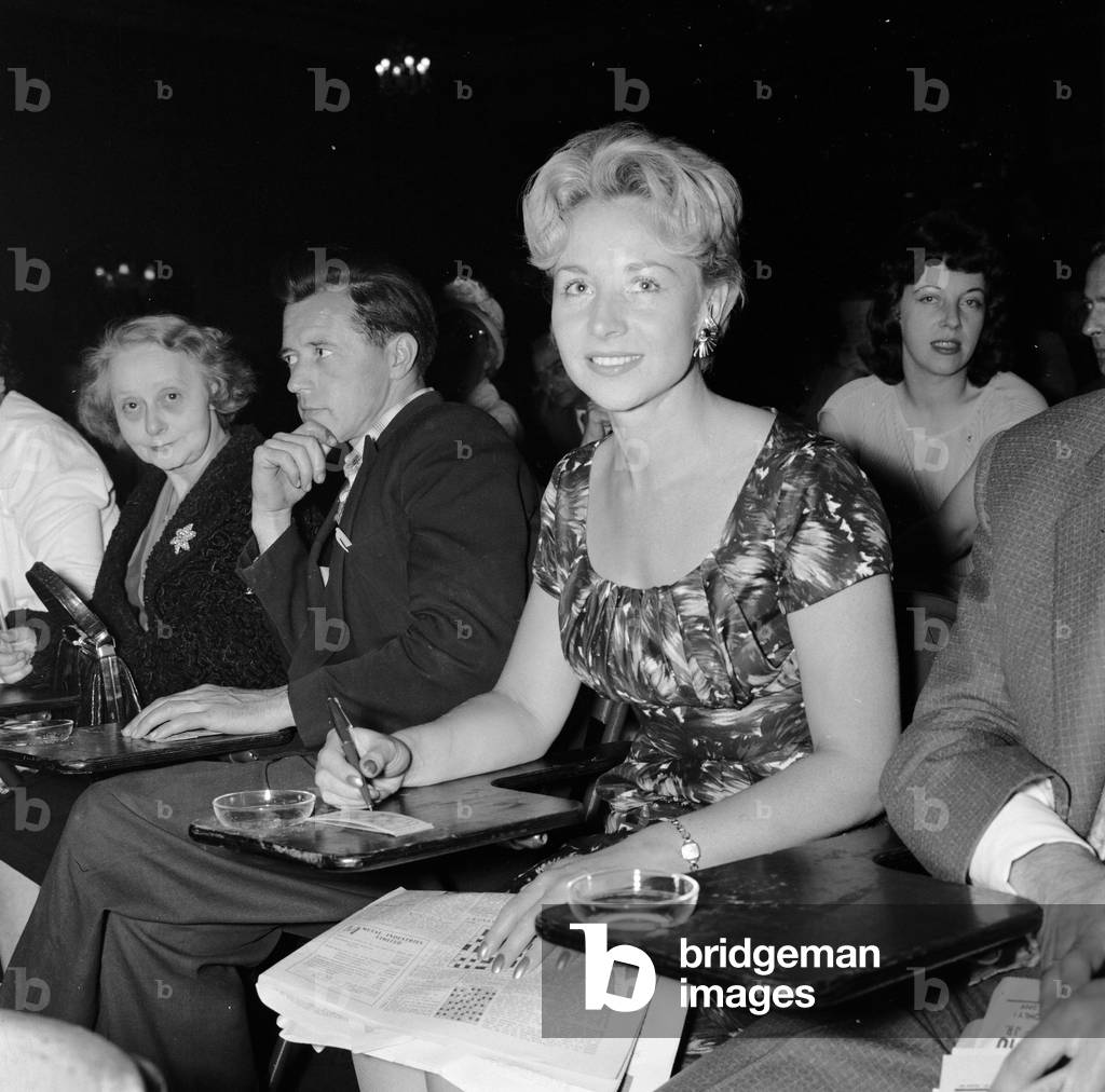 Doctor's wife Mrs Evelyn Cohen enjoys her first night out playing bingo at Maida Vale. 9th August 1961 (b/w photo)