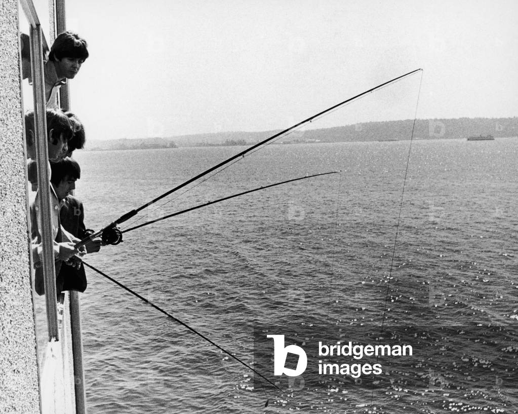 The Beatles do a spot of fishing from their hotl room in Seattle Washington 22nd August 1964.