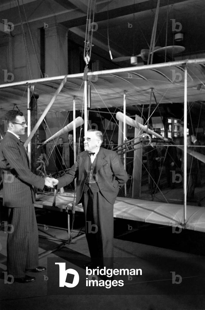 Wright Brothers 'Kitty Hawk' aeroplane, going back to U.S. from Science Museum, watched by A.V. Roe, Lord Tekenham and George Tomlinson. October 1948 O15203-005