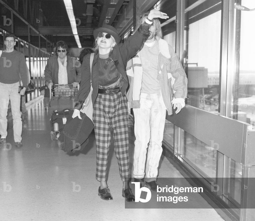 Cyndi Lauper American singer songwriter pictured with manager David Wolff arriving at London Heathrow Airport February 1987 (b/w photo)