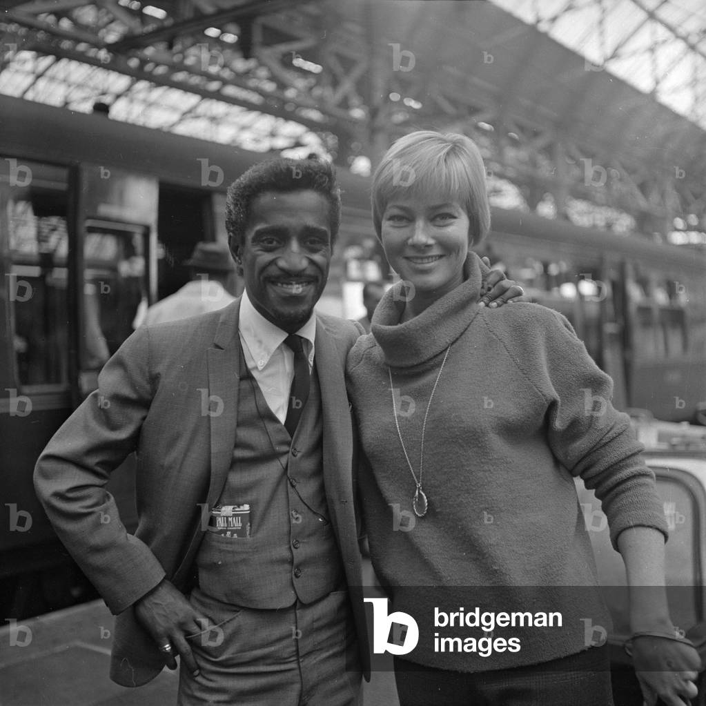 Sammy Davis Jnr and his wife Maj Eritt at Picadilly station, Manchester 9th October 1961 (b/w photo)