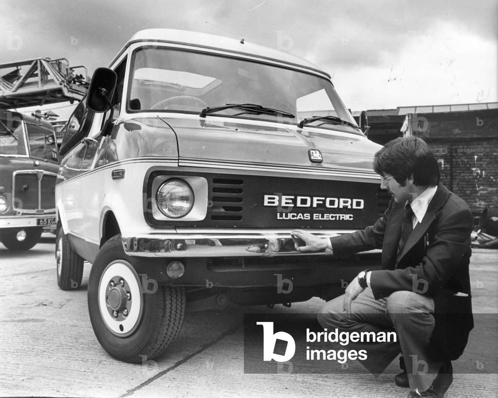 Man looking at a Bedford Lucas Electric. Sandwell firms have helped to create a 'Super Van' that never needs petrol - and makes its own power as it goes along. The van, developed by Lucas, runs on electric power using a monster one-ton battery. It employs a special recharging system in which the energy drag created by the engine slowing down goes back into the battery, Birmingham, 3rd August 1978 (b/w photo)