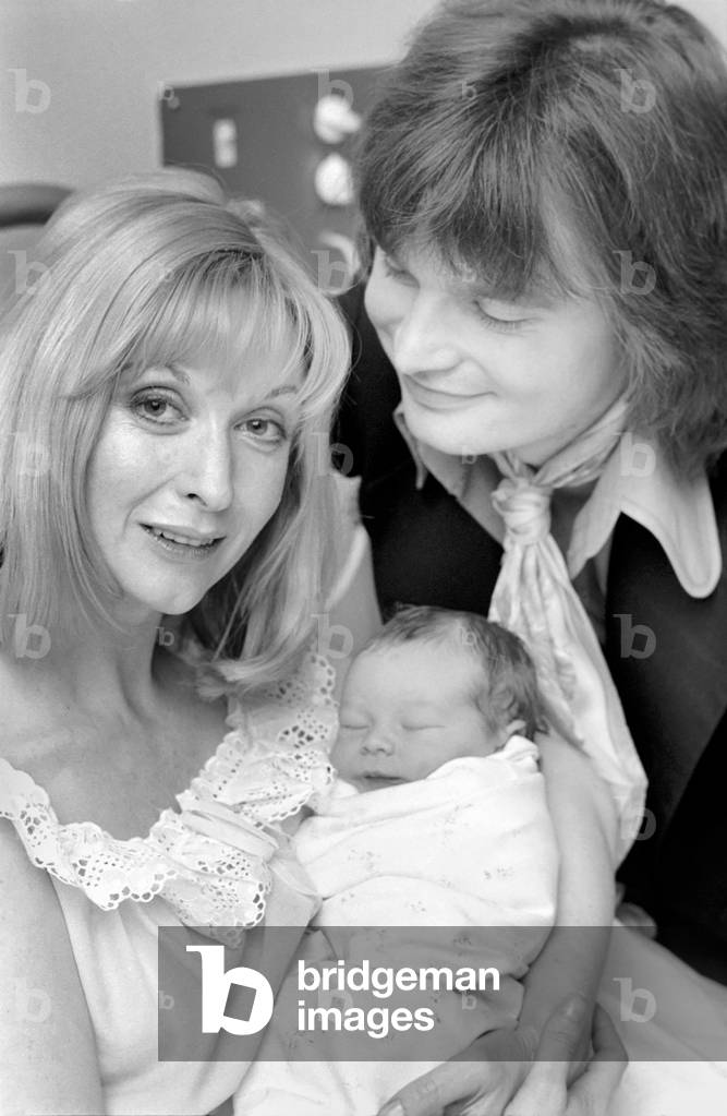 Actress: Nyree Dawn Porter with husband and baby, January 1975 (b/w photo)