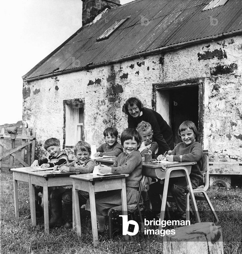 Open air lessons at Scoraig with teacher Celia Ertz outside the tiny schoolhouse, 1967 (b/w photo)