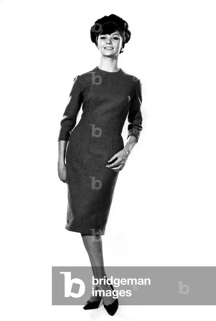 Reveille Fashions, Meriel Weston modelling a business dress with pencil style skirt without the matching scarf, 9th January 1964 (b/w photo)
