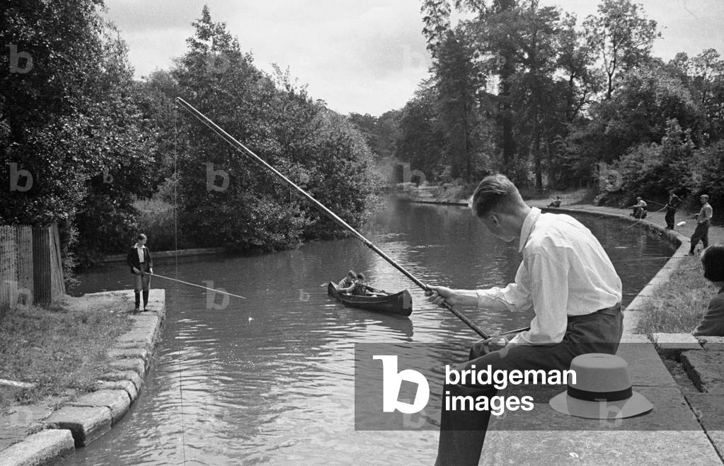 A young angler fishing in the Grand Union Canal between Rickmansworth and Watford. Circa 1950