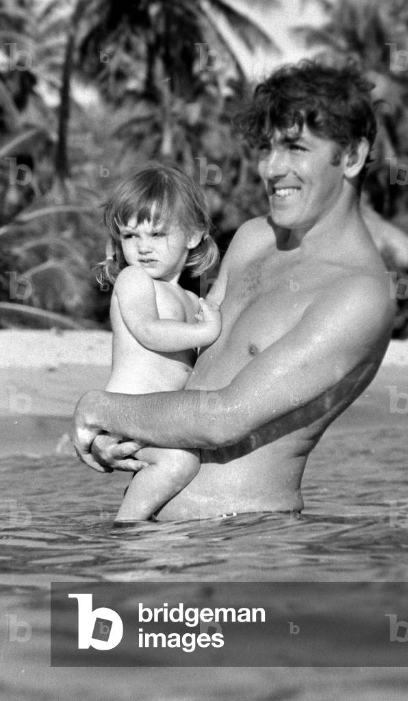 Comedian, actor and publisher Peter Cook with his daughter Lucy during a holiday in Grenada
March 1966