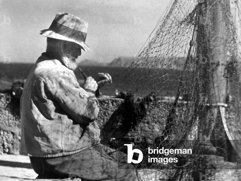 Net making, a fisherman in Cornwall, circa January 1944.

This photograph was first featured in the article 