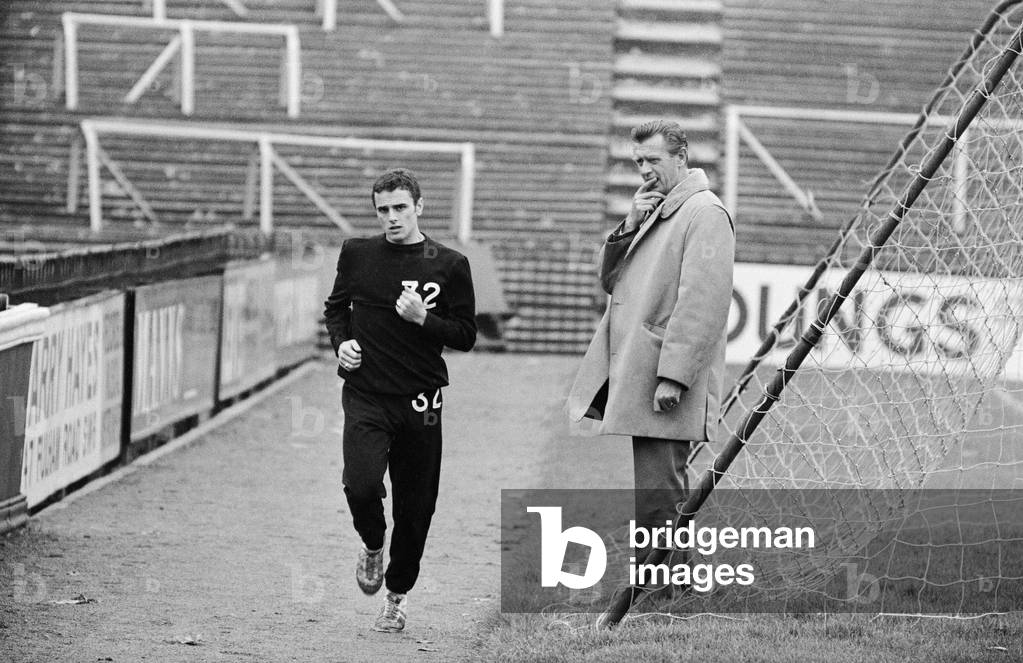 Fulham manager Vic Buckingham watches Steve Earle doing light training. 14th November 1967 (photo)