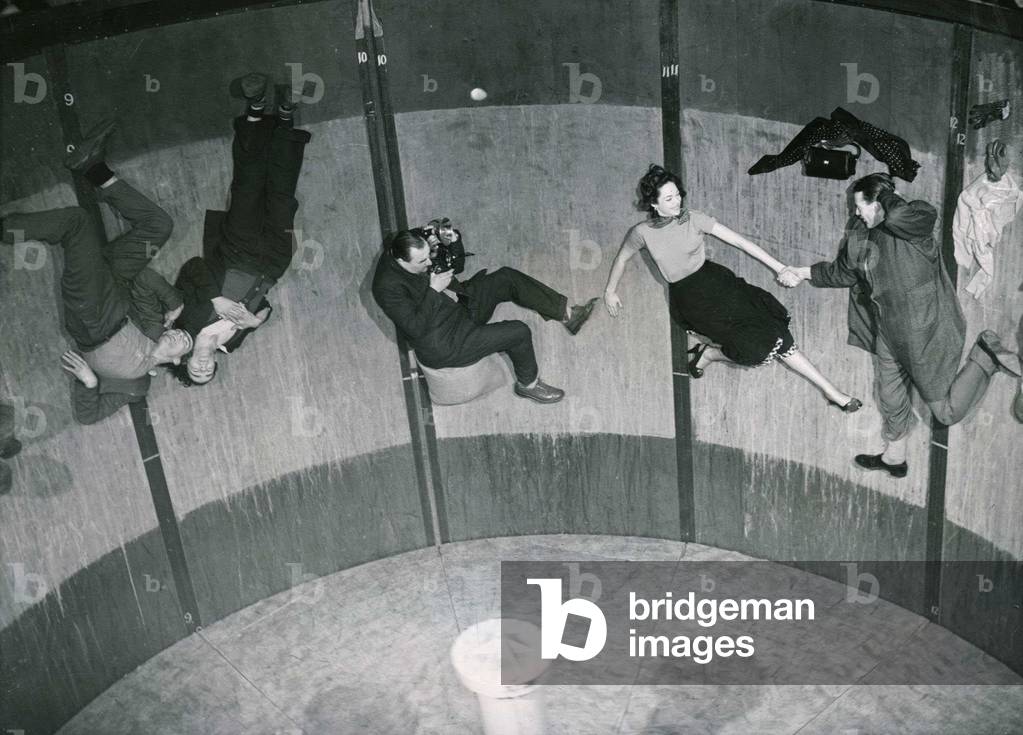 Photographer frank Charman tries to photograph actress Natasha Parry on the Rotor ride at Olympia after the completion of the film January 1951 (b/w photo)