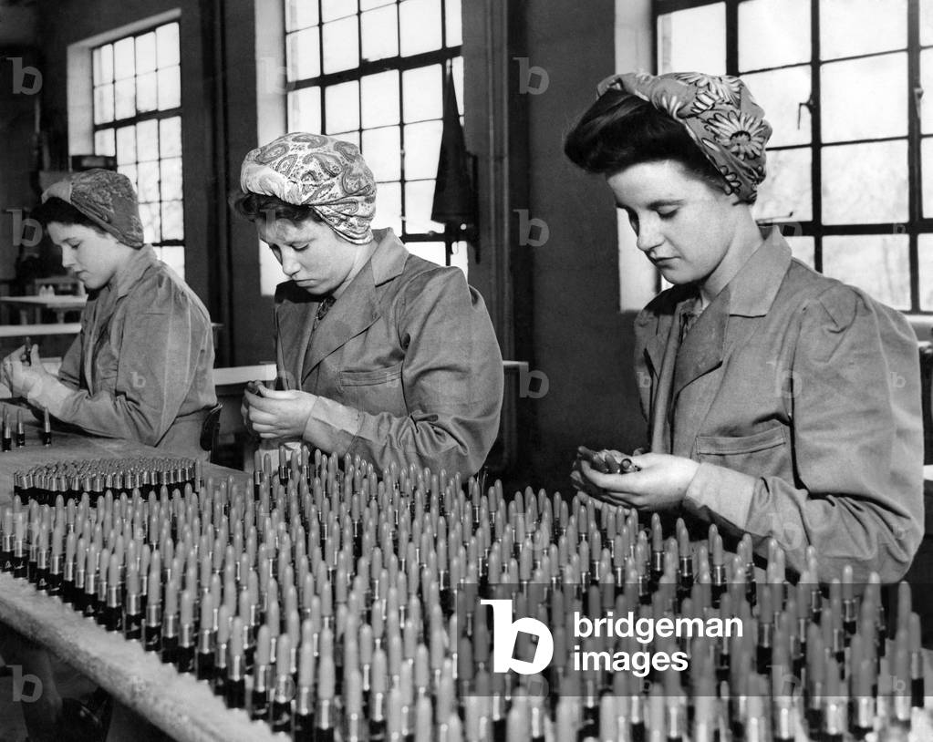 Girls at a Lanchester County Durham factory helping to pack lip sticks for export. The girls, mostly miners daughter are getting a chance to put the name of their village on the world map. (b/w photo)