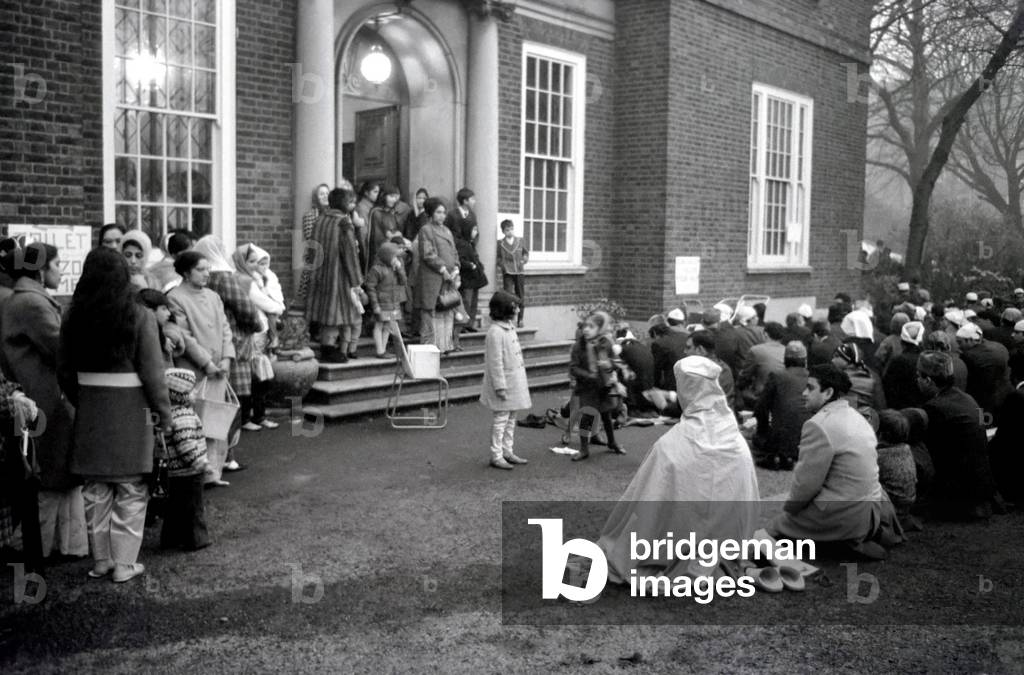 On a murky foggy December day between five to seven thousand Muslims of many nationalities assembled at a Islamic Cultural Centre in Regents Park to celebrate the Id-Ul-Fitr. Many marquees were put up for people to play in while the overspill knelt outside on prayer carpets, blankets and newspapers. December 1969