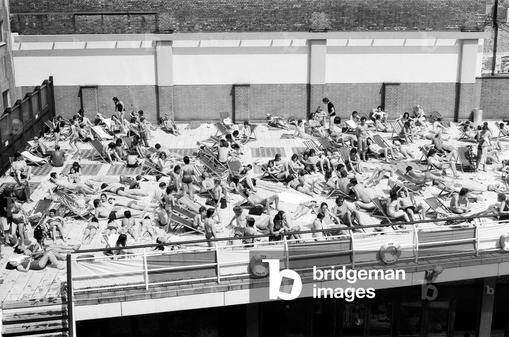 People enjoying the hot weather at the Oasis outdoor swimming pool Lido, London. 7th June 1975 (b/w photo)