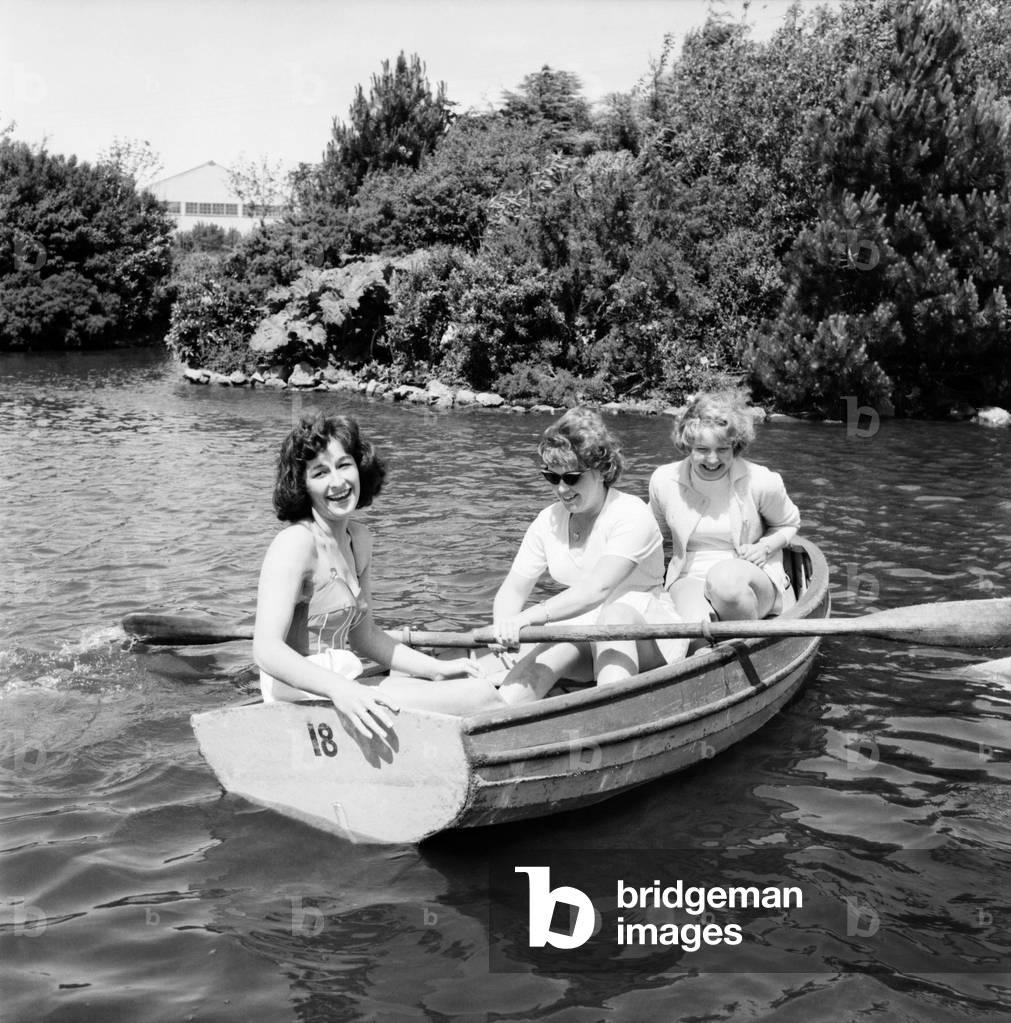 Bultins Holiday Pwllheli: Mrs. Nellie McGrail, Pools Winner. Horse riding/Boating/Elephant/Roller skating/Family. The McGrail girls go baoting - Irene rowing with Barbara and friend Brenda Parsonage. June 1960