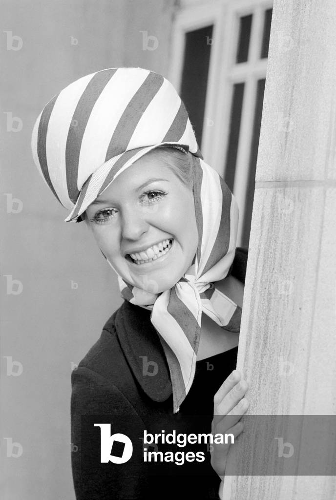 The Millinery Guild showed their Spring Collection of hats at the Dorchester, London. Jane Whiteley wearing a sun hat - shades of the Foreign Legion in crisp navy and white stripes by Gina Davies. 
November 1969