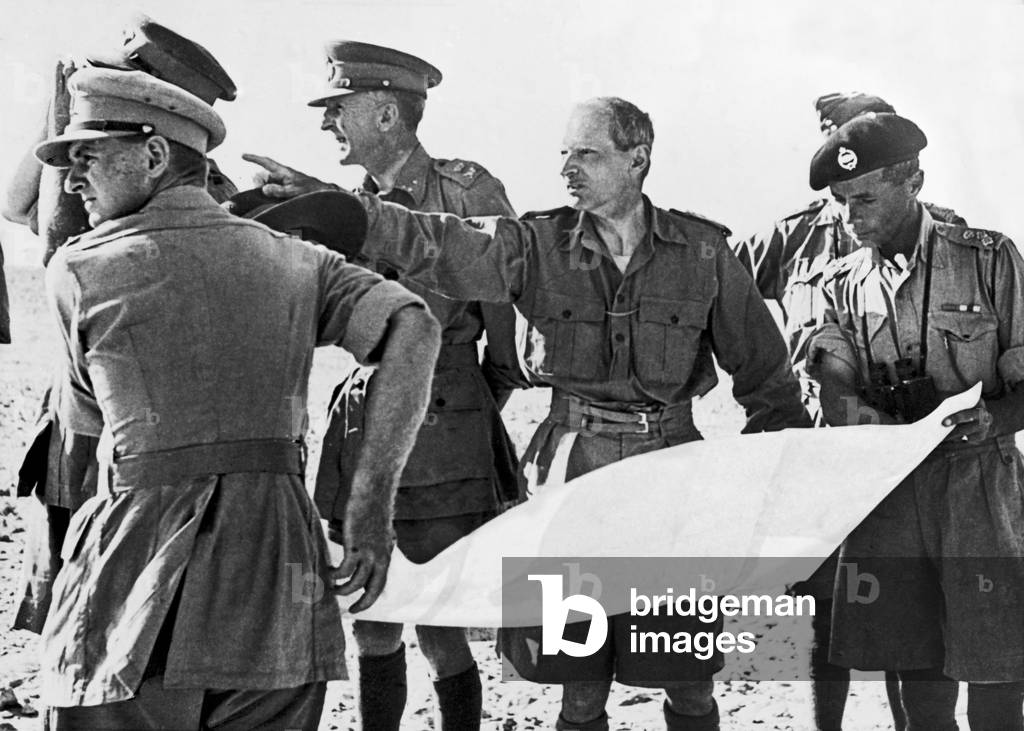Lieut General Bernard Montgomery newly appointed commander of the 8th Army seen here discussing tactics with officers from the 22nd Armoured Brigade, to the right of Montgomery is Lieut General Horrocks. August 1942