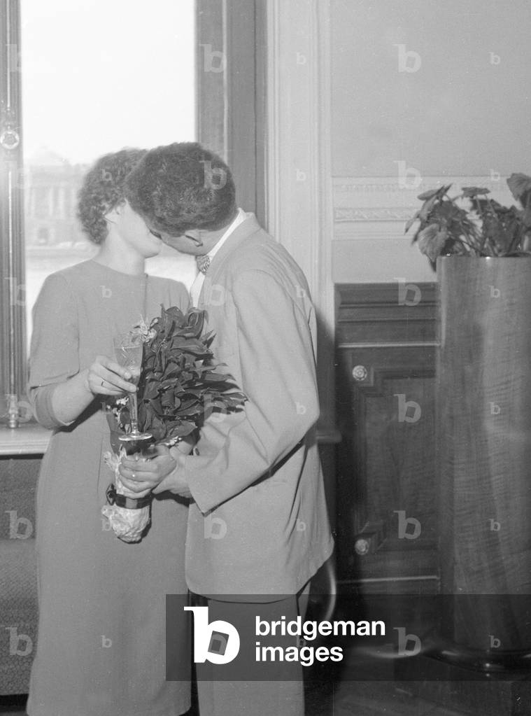 A newly married Russian couple kissing in the registrar office in Leningrad. April 1960