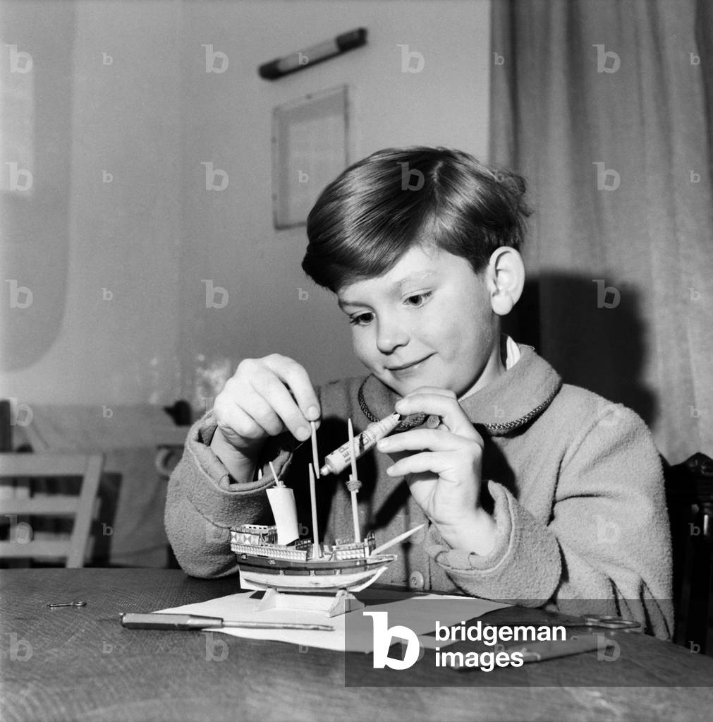 Young boy making a model replica of the HMS Victory, the ship of Lord Horatio Nelson. 
October 1952 
C5179