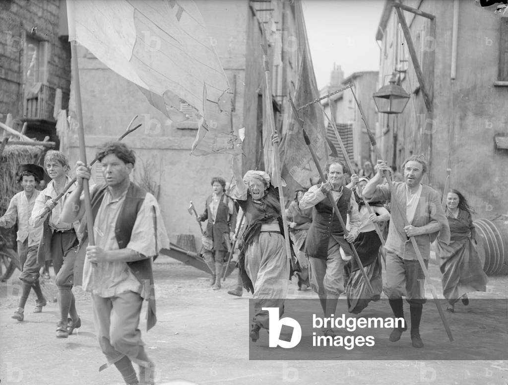 Rita Tobin (centre) seen here as a film extra re enacting the storming of the Bastille at Pinewood Studios as part of the making of a cinematic version of Charles Dickens 