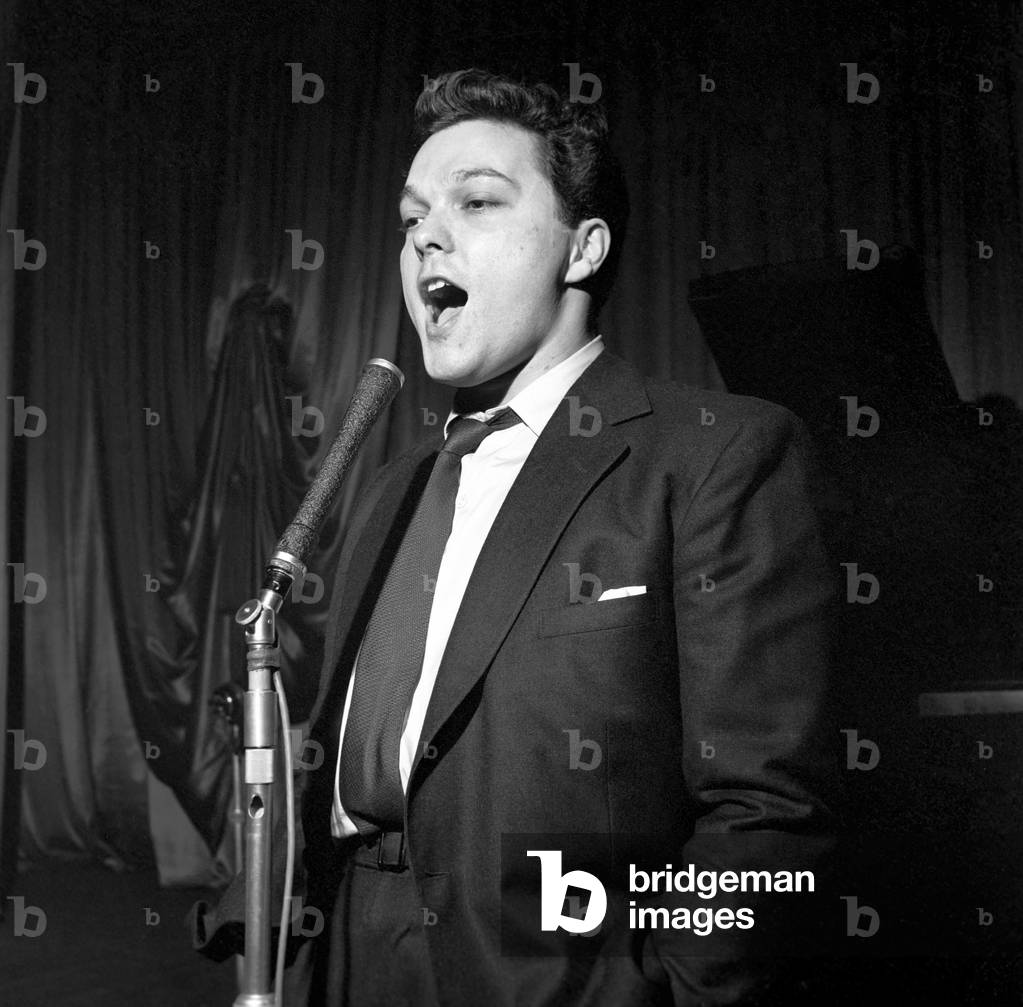 Singer Dickie Valentine seen here performing on stage, 1954 (b/w photo)