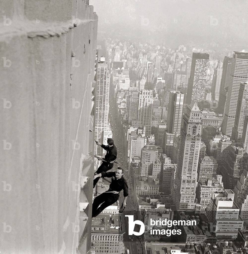 Window Cleaners 1000 feet above the side walk cleaning the windows of the Empire State Building, December 1964 (b/w photo)