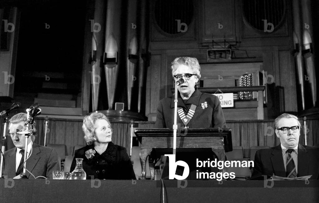 Mrs. Margaret Thatcher Talks to Tradesmen. Mrs. Thatcher looking up to Miss Mildred Head speaking, February 1975 (b/w photo)