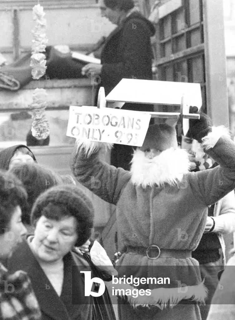 David Burbidge was in his Santa outfit selling sledges in Glasgow when the police arrived on horseback and told him to hitch up his reindeer and leave, 18th December 1978 (b/w photo)