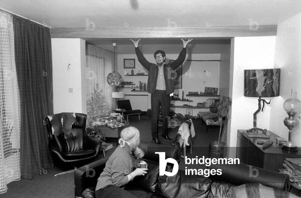 Singer Rolf Harris who lives in Sydenham, Kent, has bought the house adjoining his own modern terrace. He decided he would like to enlarge the three bedroomed house and knocked down the brick wall between the houses, himself. Rolf and his sculptress wife Alwen live their with their five year old daughter Bindi. 
December 1969