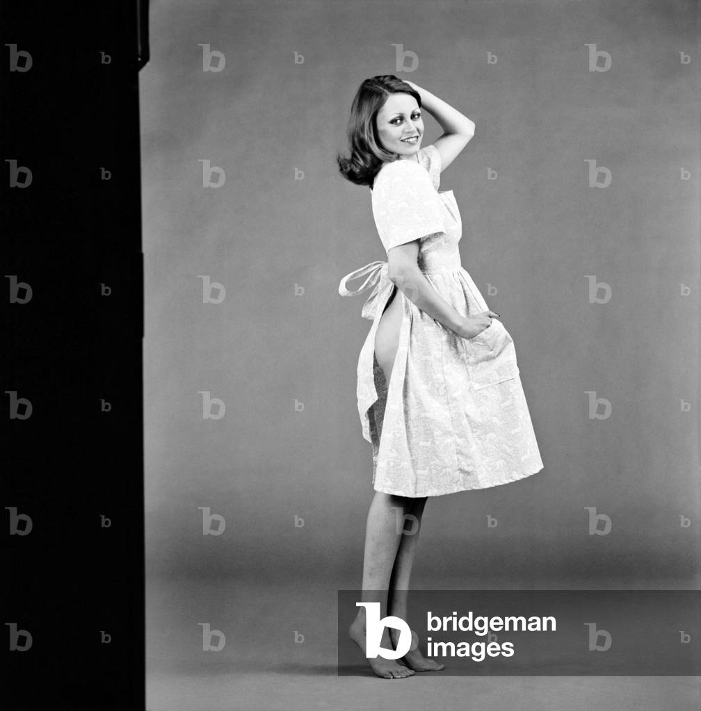 Glamour girl Geraldine June wearing a pinafore. 
January 1975