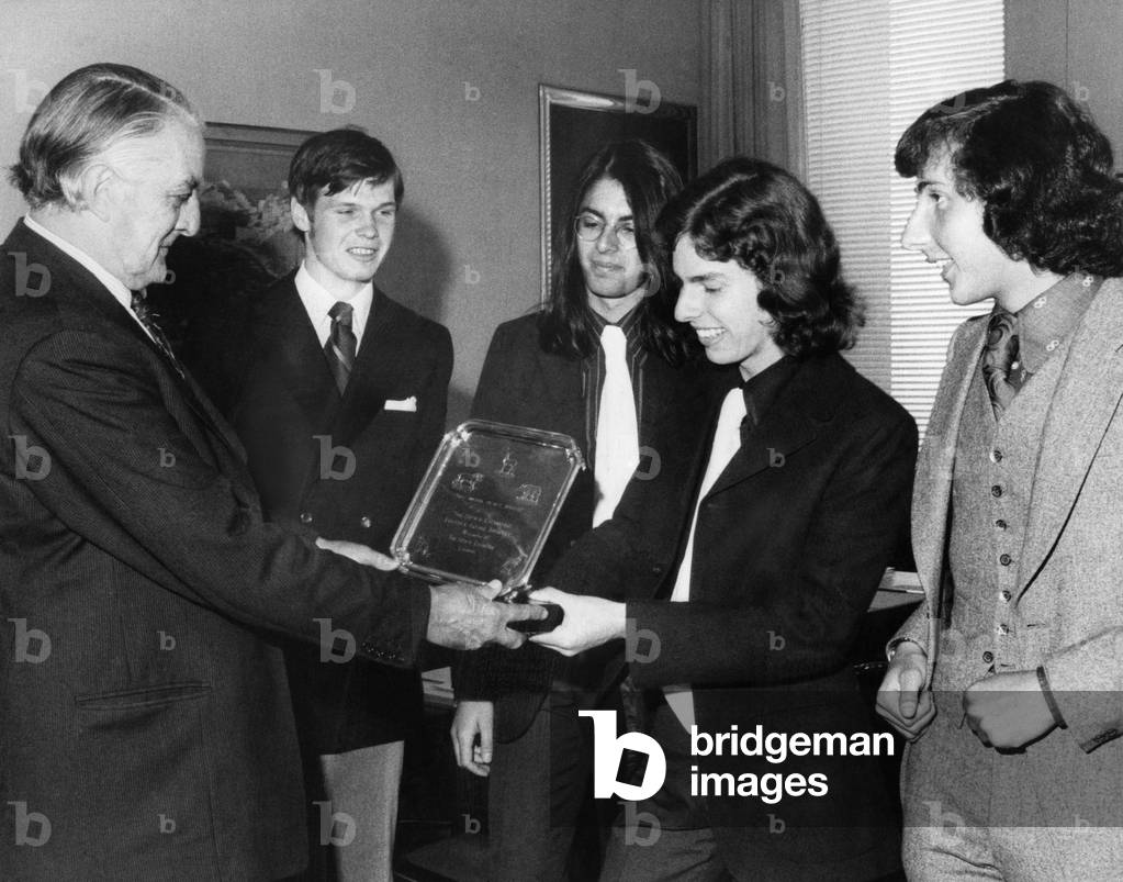 Chairman of the Stock Exchange, George Loveday, presents the winning trophy to Haberdashers School pupils.
