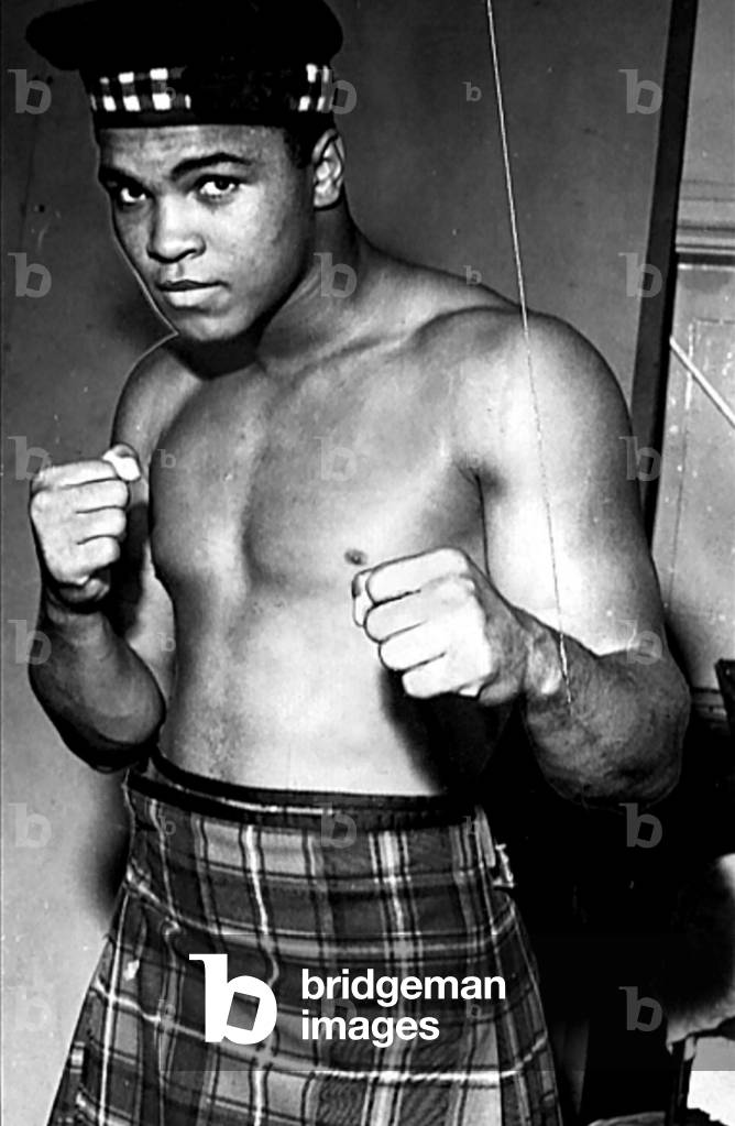Muhammad Ali (a.k.a Cassius Clay) Boxer June 1963
Dressed in tartan kilt glengarry hat clenched fists