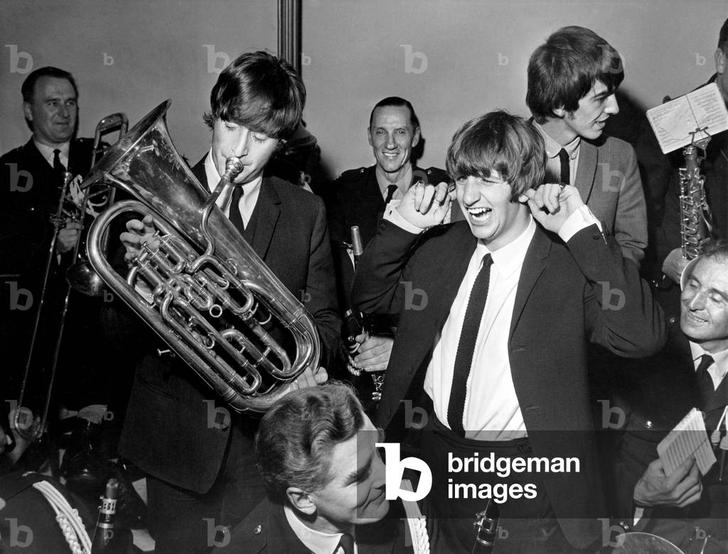 The Beatles in Liverpool, Friday 10th July 1964. Back home for evening premiere of 'A Hard Day's Night' at the Odeon Cinema. Pictured playing with instruments belonging to Police Band, Civil Reception, Town Hall.
