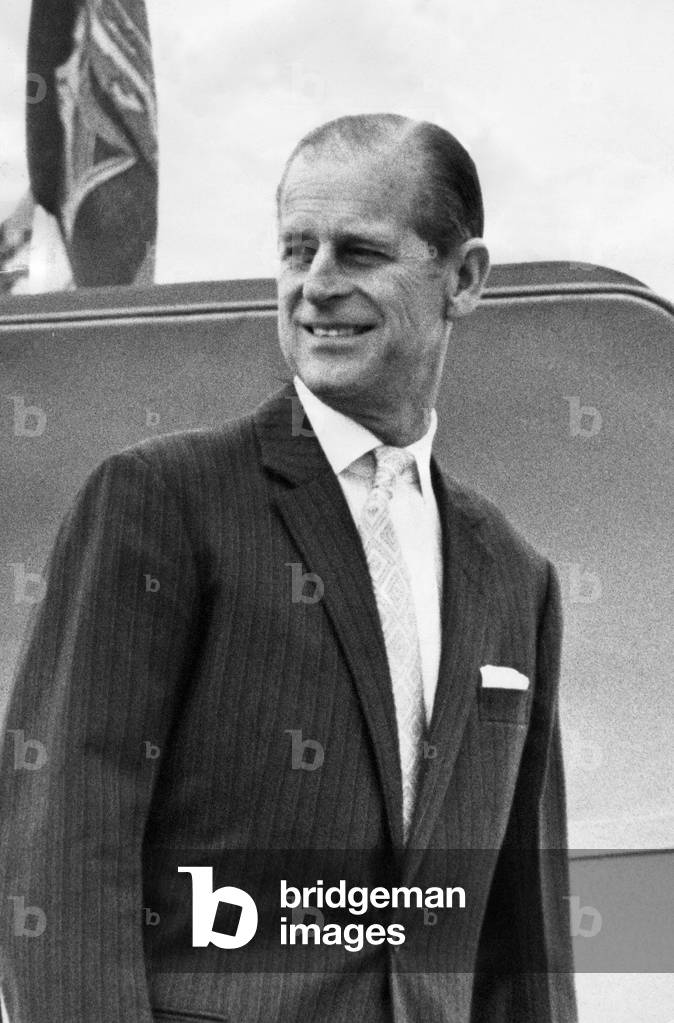 Prince Philip, Duke of Edinburgh, smiles and waves as his board the aircraft, 01/07/1975