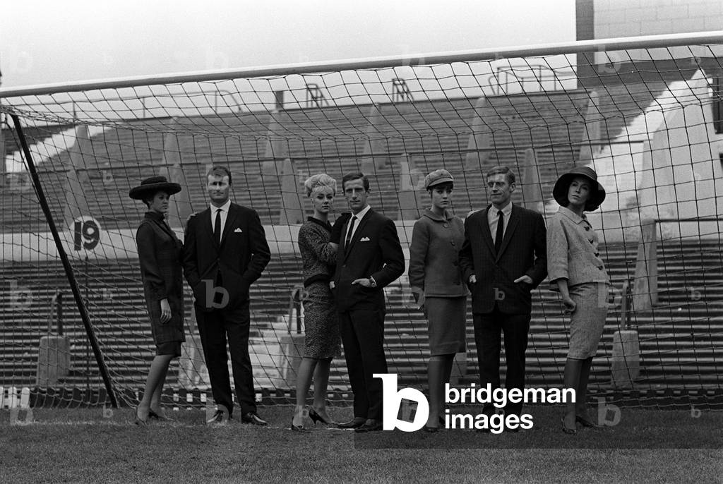 Noel Cantwell of Manchester United September 1963with models and teamates posing for fashion shoot standing in the goal mouth (photo)