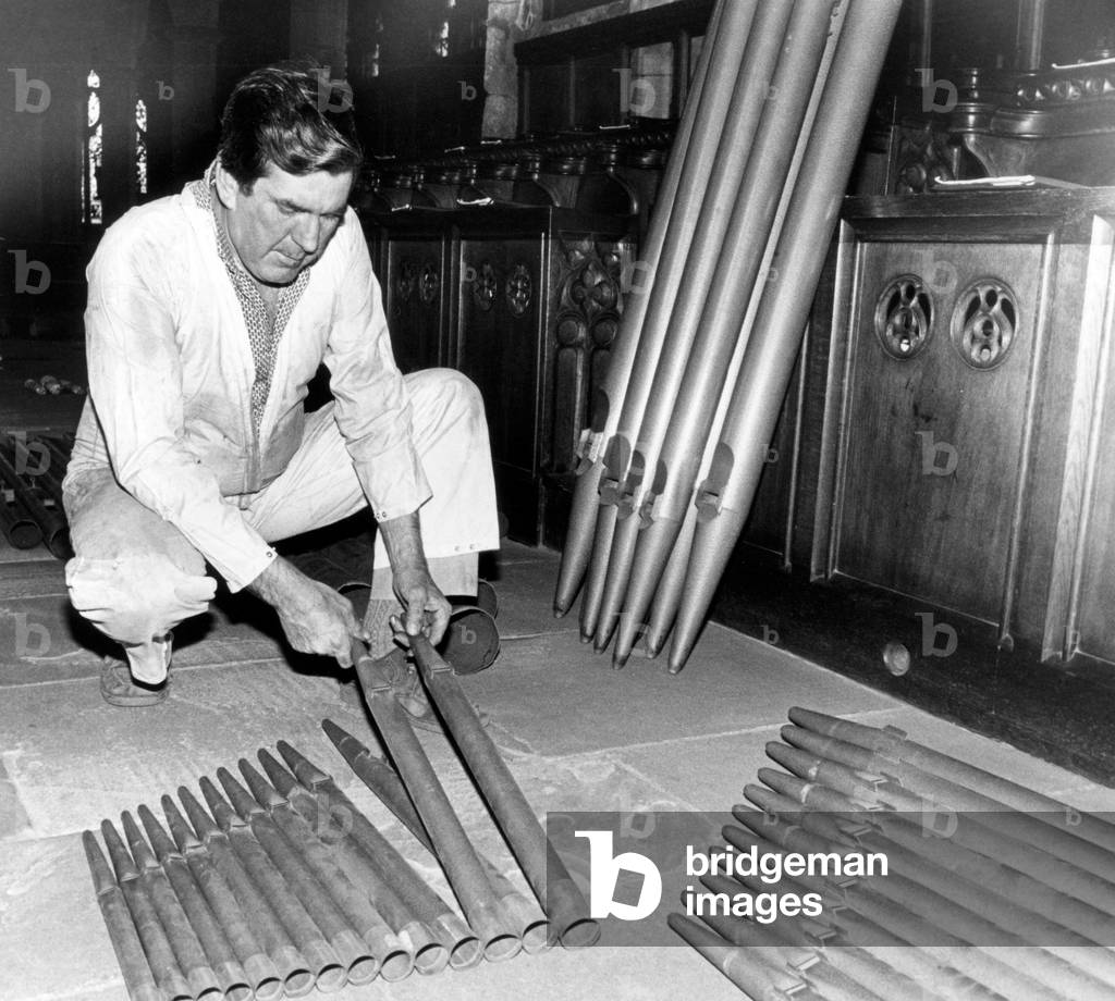 A new church organ being installed at Guisborough Parish Church, workmen are removing the old console and pipes which will be repaired and then used with the new extension organ, 27th August 1982 (b/w photo)