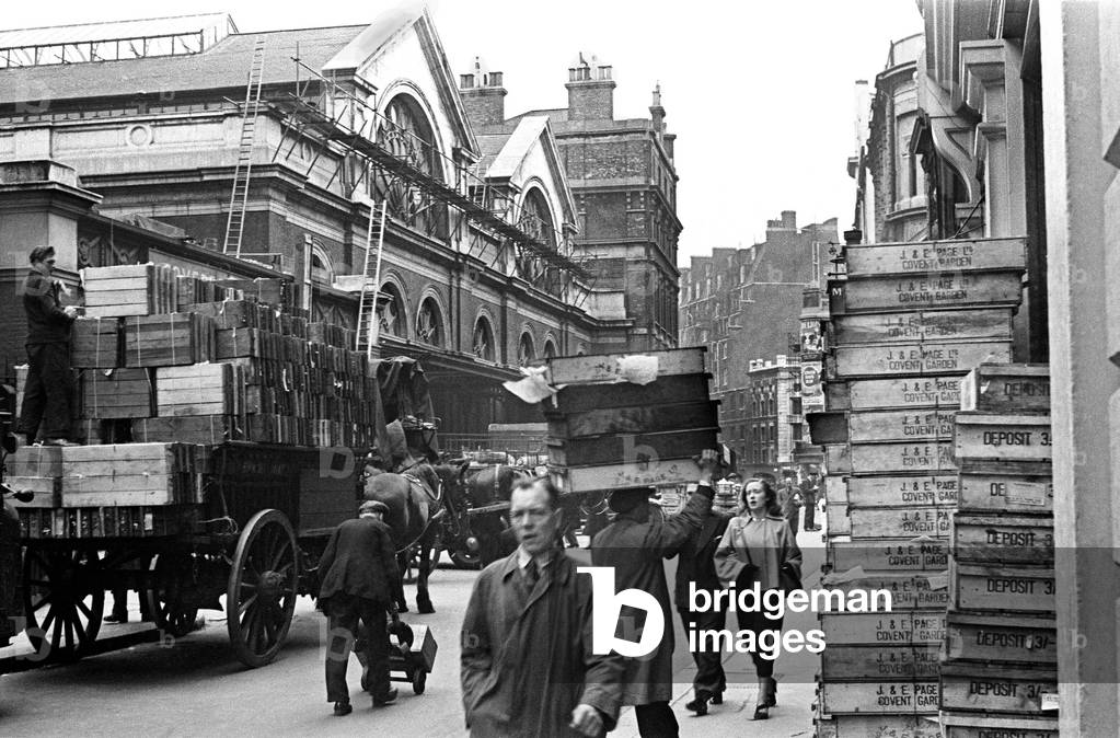 The deliveries and the loading of purchases of fresh fruit and vegetables in a congested Tavistock Street WC2 at the rear of Covent Garden Market. c. 1948 (b/w photo)