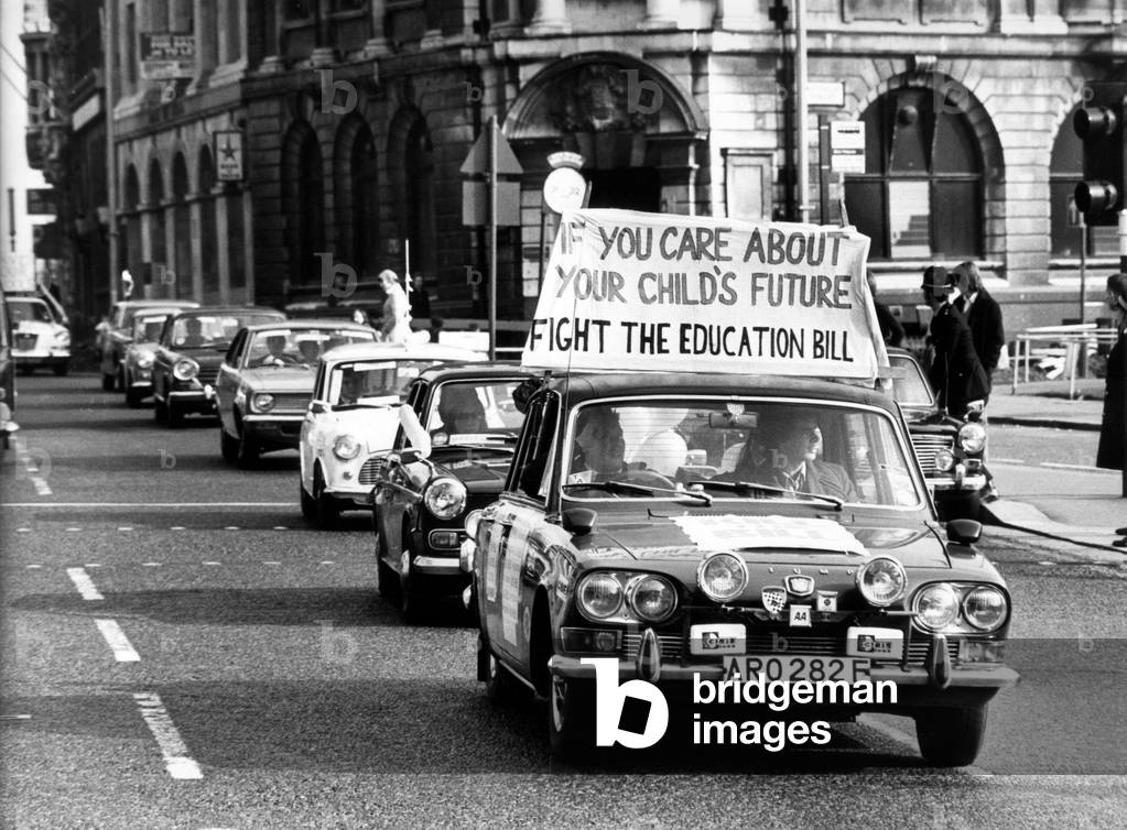 A car cavalcade through Birmingham city centre in a protest against the Government's Education Bill. The protesters were parents and supporters of Birmingham's King Edward's Grammar Schools. The banner on the car reads 'If you care about your child's future fight the education bill'. 27th February 1976 (b/w photo)