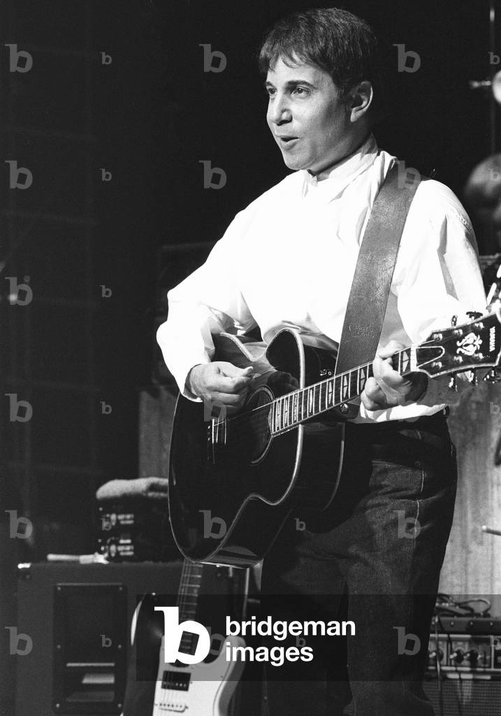 Paul Simon seen here performing on stage at the Royal Albert Hall during his Graceland's tour. 7th April 1987 (b/w photo)