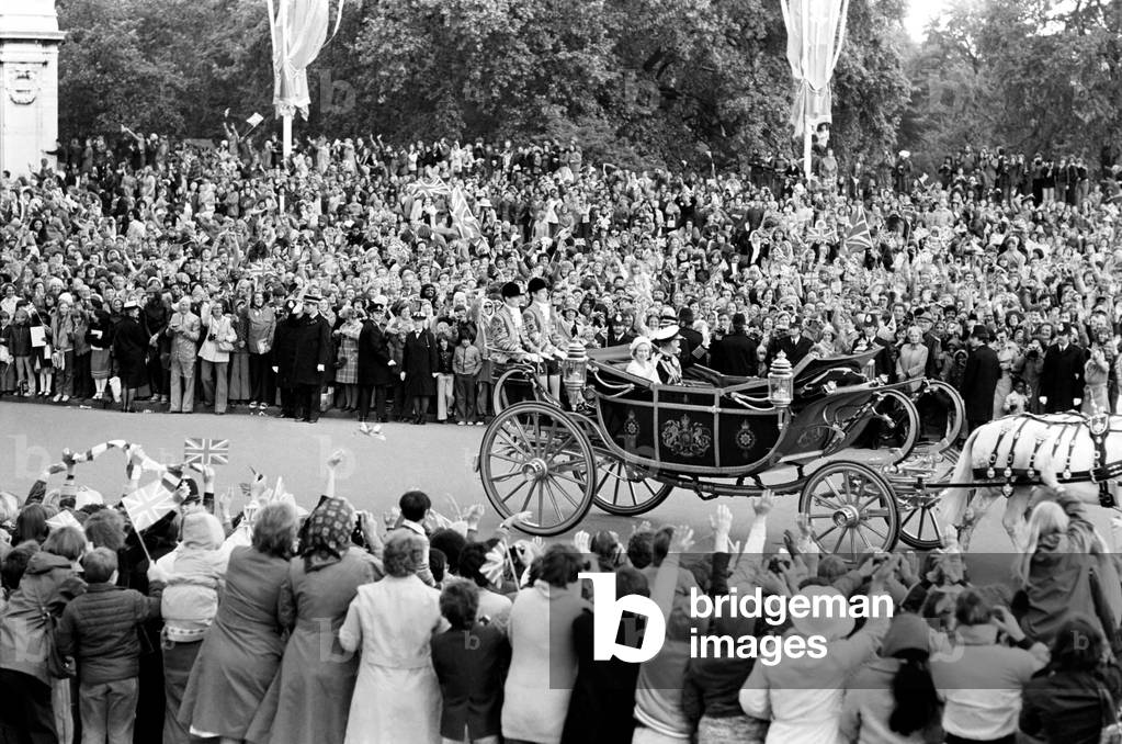 Crowd waving to the carriage of Queen Elizabeth II and Prince Philip, Duke of Edinburgh during Silver Jubilee celebrations, 7th June 1977 (b/w photo)