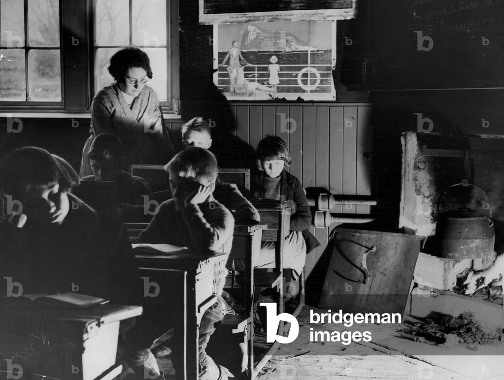 Children sitting at their desks in their school classroom on the Isle of Lewis in the Outer Hebrides, Scotland.
December 1934