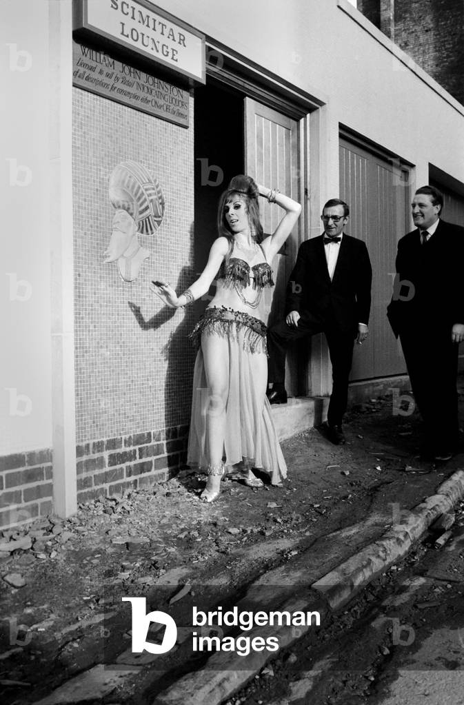 A woman belly dancing for men at The Turks Head Pub in Birmingham. November 1969 Z11189-007